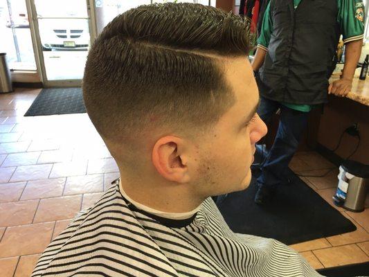 Mid skin fade with a comb over by Mike.