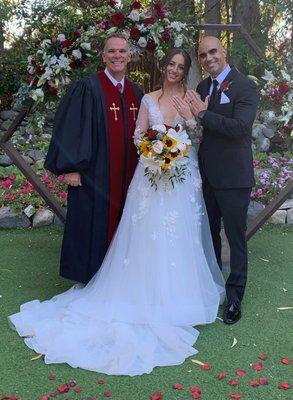 Rev. Dr. Jeff Saville and bride and groom showing off rings