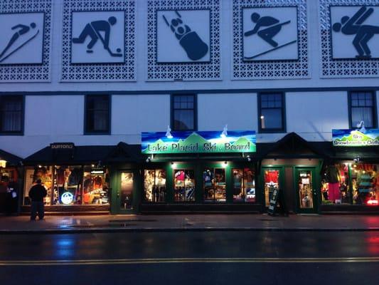 night time pic of store. located by the bobsled on the sidewalk