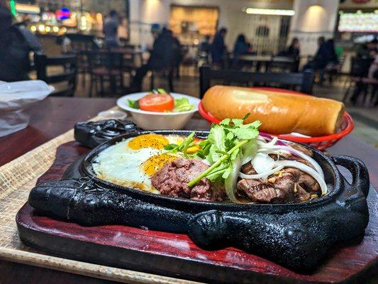 Vietnamese steak & eggs on cast iron plate