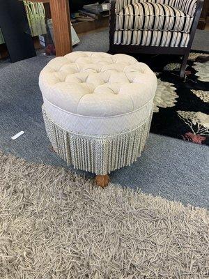 Tufted ottoman with bullion fringe.