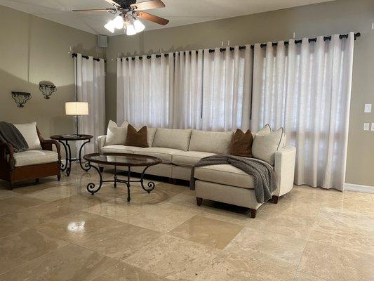 Custom Drapes with grommets and Custom sectional sofa and pillows.