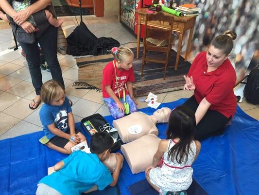 Ashley Teaching children how to give 2 breaths!