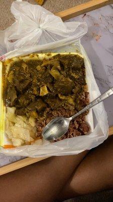 Curry goat, rice and peas, steamed veggies