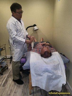 Dr. Chihkang Michael Chou Daom with one of his patients at his San Jose office.