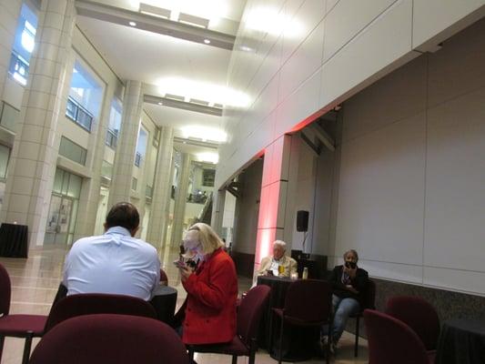 tables and chairs outside the auditorium where you can sit and have a drink or two and some nibbles