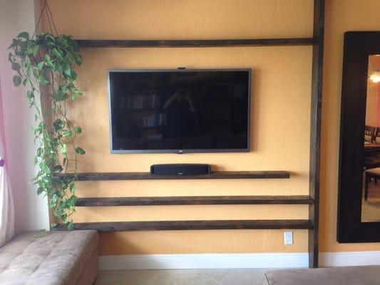 Custom wall mount.  All a/v equipment completely hidden with custom remote.