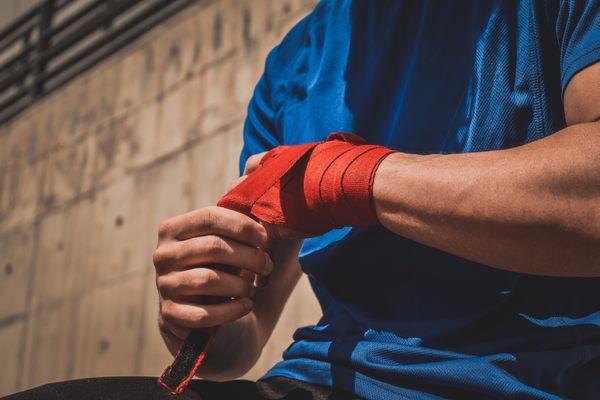 Athlete stretching red taped wrist