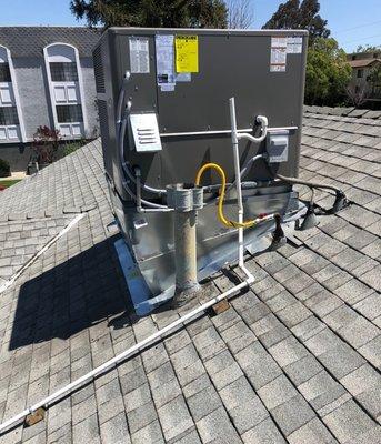 Installation of a Lennox 4 ton air conditioning 14 SEER package unit and new metal curb on a rooftop in Sherman Oaks, CA.