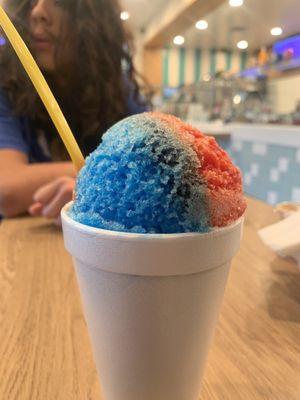 Mini shaved ice put in...a styrofoam cup. Be aware to check the middle of the shaved ice. Mine was plain ice with no syrup.