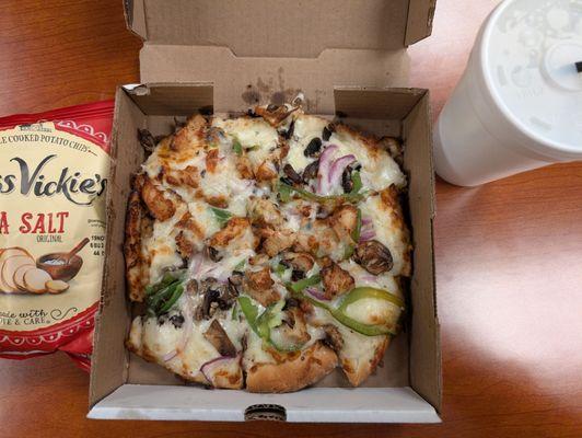 Personal chicken gourmet pizza with a soda and chips. Super creamy!