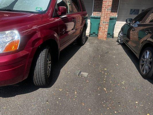 Thrown from the roof, hit the red car and bounced on the ground. I saw it happen from my kitchen window.