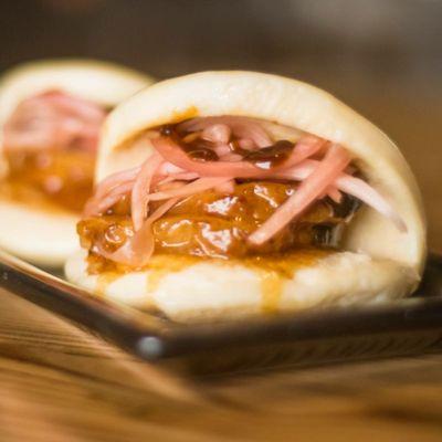 Pork Buns served with soft bao, pieces of sweet marinated pork and aged pickled red onions