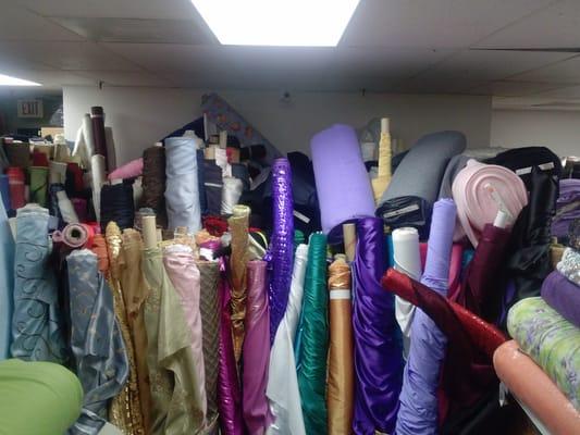 Fabrics piled deep. How anyone finds those in the back, I have no idea.