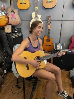 Behind the counter testing guitars