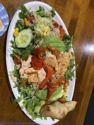 Salmon with arugula, avocado, cucumbers, roasted red peppers