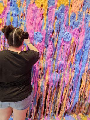 My girl and the slime wall at Sloomoo!