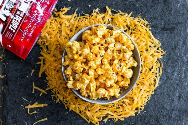 Chicago Baked Cheddar flavored popcorn, available in popcorn bags and tins!