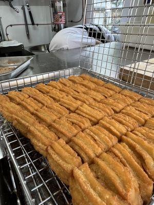 Churro bites ready for their sugar and cinnamon shower.