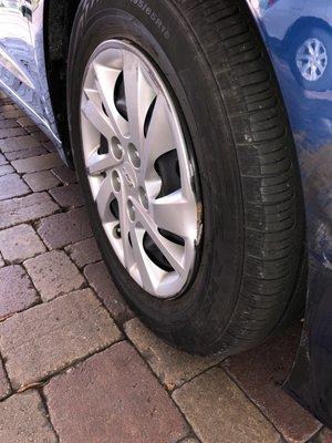 Damaged wheel and wheel cover on car presented to us.