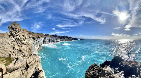 blue waters and sheer lava cliff face