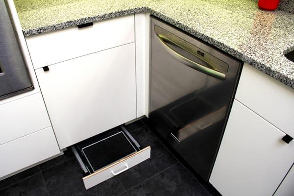 Folded ladder as a drawer in the bottom of the cabinet.