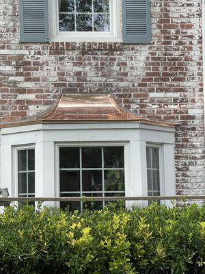 Beautifully done custom fabricated copper roof over the bay window.