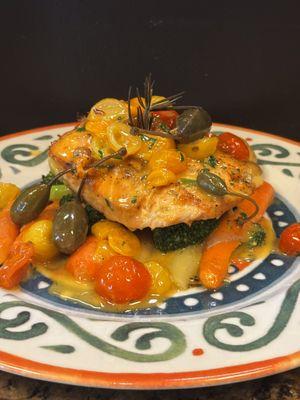 Pan seared fresh scotish salmon in a multicolored tomato and berry capers