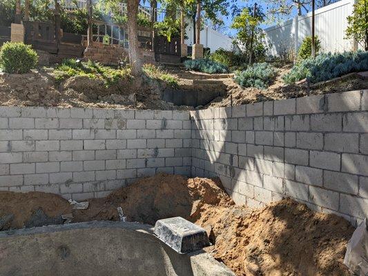 This is what TRC considers a completed wall. Rebar still sticking out from the top