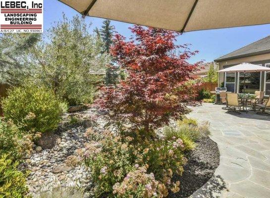 Installed in 2014 this picture was taken in 2018. Designed as a nature preserve, dry river bed, flagstone patio and walkway.