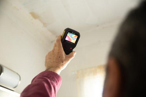 Jim Johnson looking for moisture during  a mold inspection.