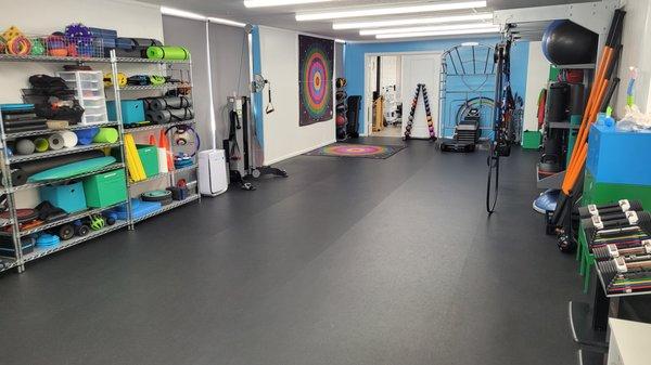 Open gym space with plenty of functional strength training equipment.