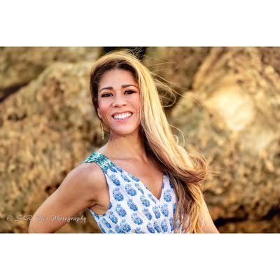 Headshot of a woman on beach during sunset.