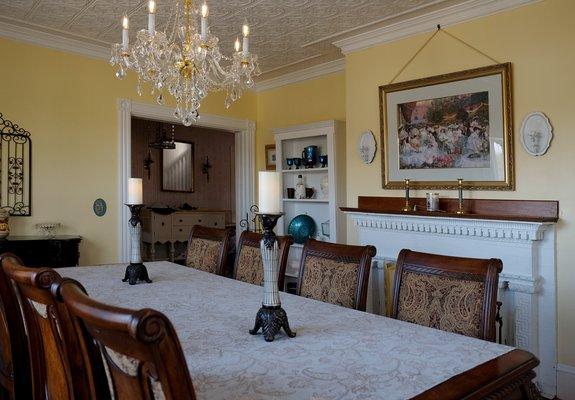 Formal dining room with original tin ceiling and fireplace.