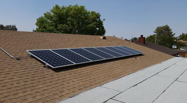 A straightforward roof-mount array. Comp shingles, flush mounted.