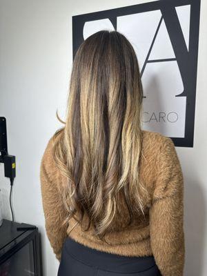 Long hair transformation with warm highlights, perfect for December 2024. A festive dimensional look that shines for the holiday season.