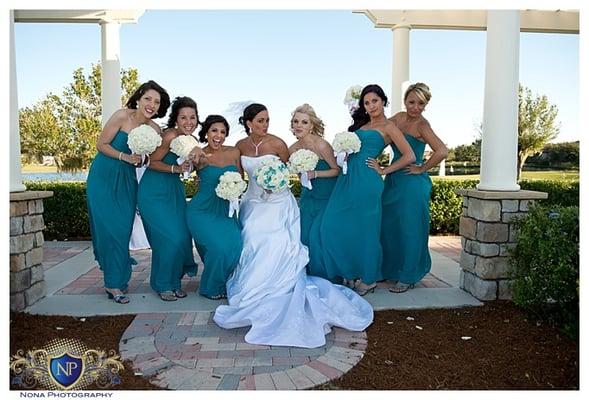 Bride and Bridesmaids pose for a quick silly photo at Eagle creek golf club