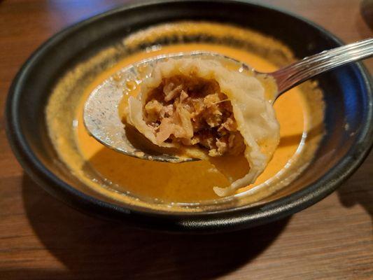 Inside a steamed lamb momo served with jhol