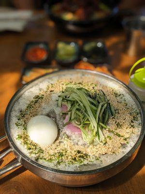 The most aesthetic Naengmyeon with some frothy top and sesame seeds