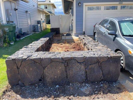 Rock wall on the other side of the front yard.