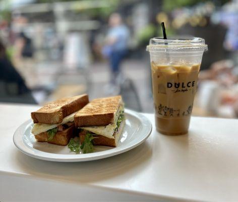 Breakfast sandwich and iced oat milk latte.