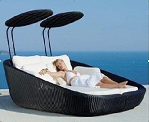 Rattan daybed for chilling out poolside.