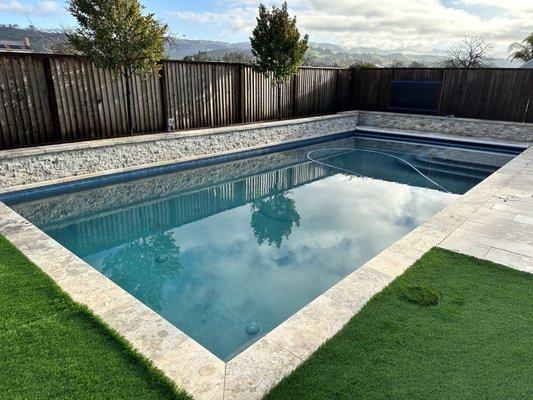 Pool, safety cover, travertine surround, travertine retaining wall, patio & turf all completed by Francisco's team.