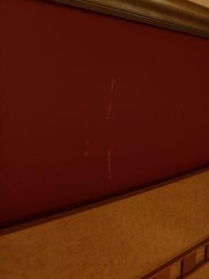 Scratches above bed headboard....classy