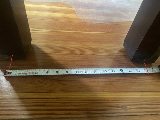 Measurements showing legs of desk are same distance apart as damage