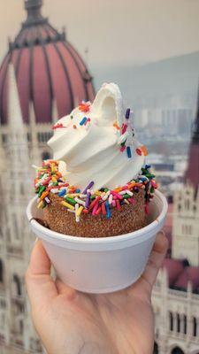 Cinnamon Sugar chimney cake with Nutella spread (4/5) with vanilla ice cream (3/5) and rainbow Sprinkles