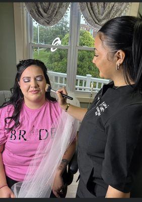 Our Make Up artist adding the finishing touches to the bride for her wedding.