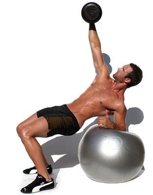 Adam Winter performing a dumbbell press on a stability ball!