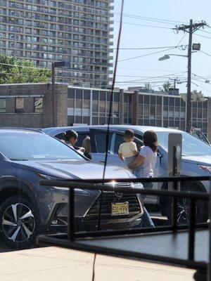 Picture of 2 of the hair stylists socializing outside as we were inside waiting for haircuts