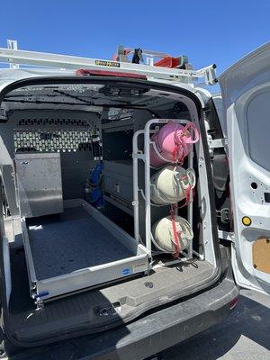 Refrigerant tank storage, lockable cabinet and shelving, and slide-out cargo tray